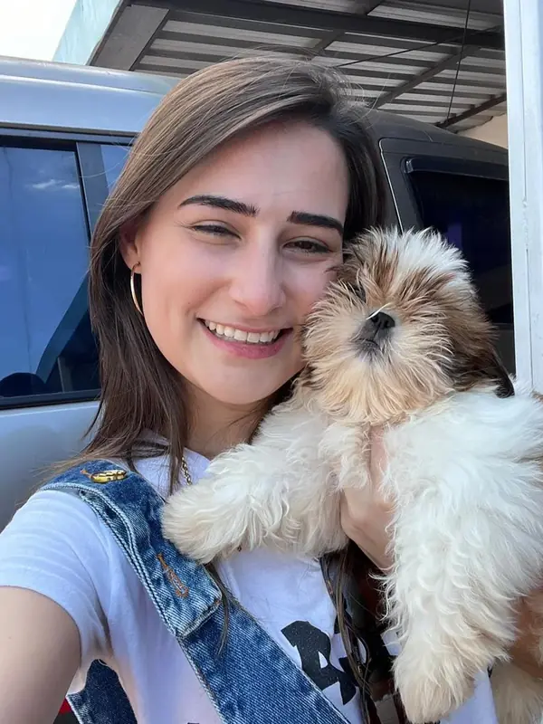 Sardie in Utah taking a selfie beside her car with Queen, a gold and white Shih Tzu puppy